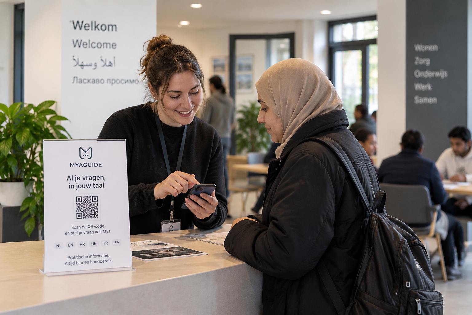 An employee helps a resident with MyaGuide at the reception desk of a reception location.
